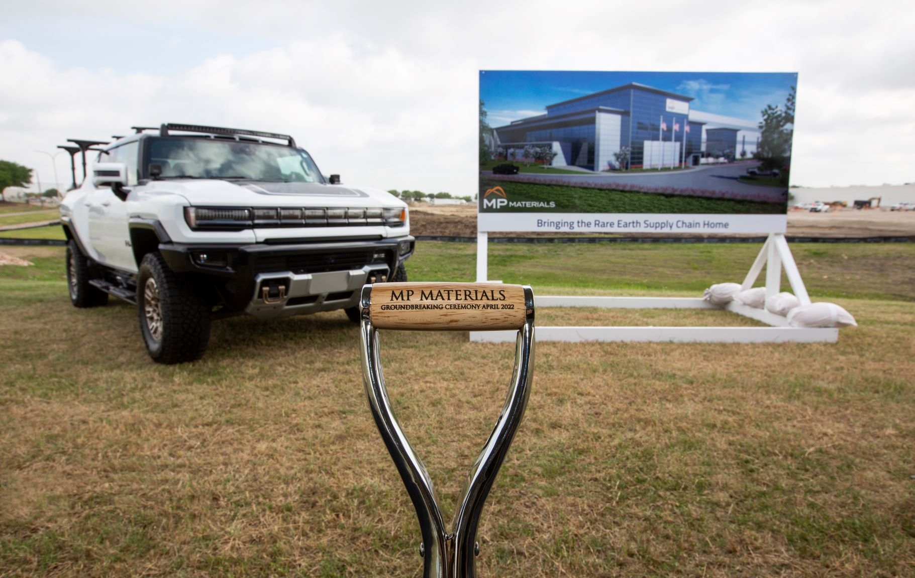 A truck and a large sign are seen at a groundbreaking event for MP Materials at AllianceTexas.