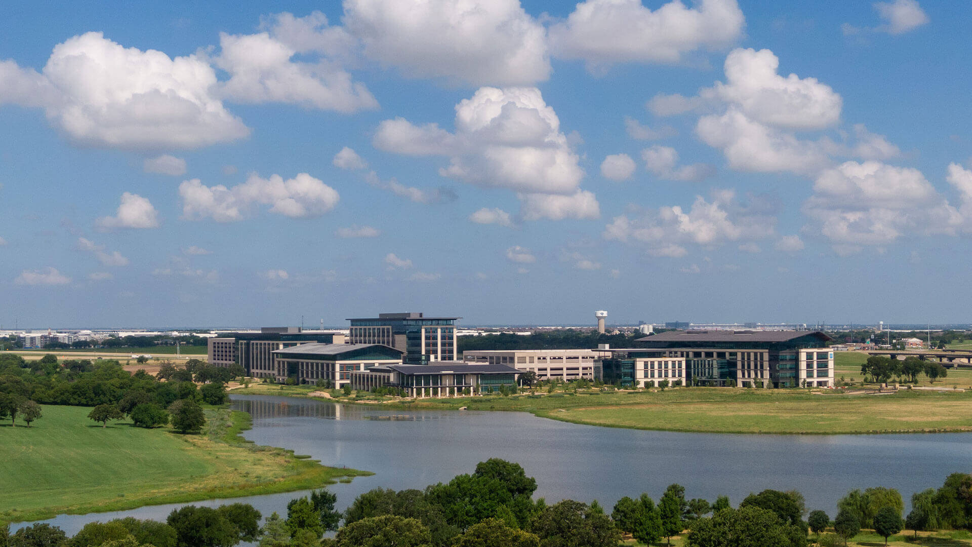 Wide-angle view of a lake and building complex.