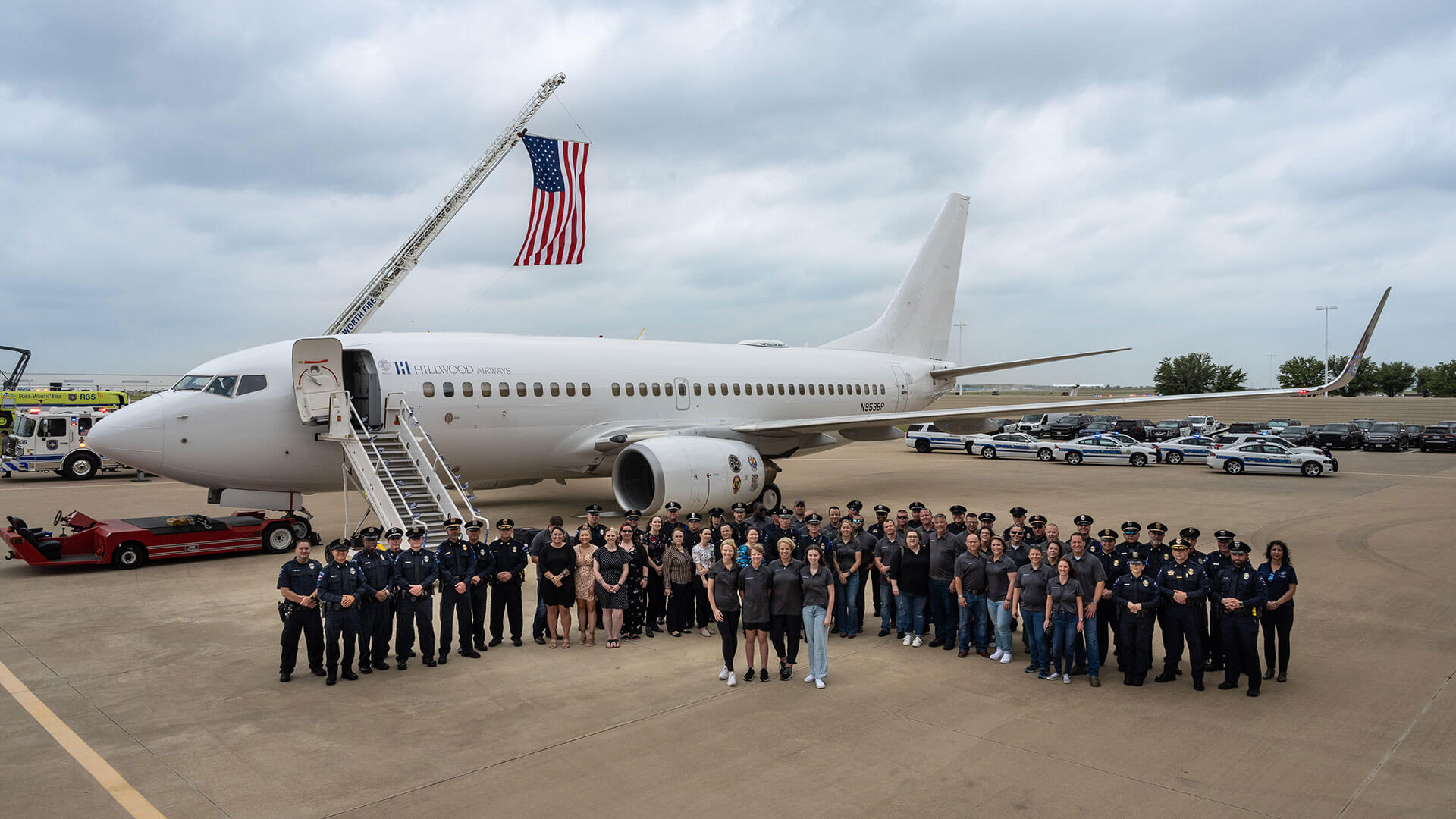 Hillwood Airways employees gather on a tarmac.