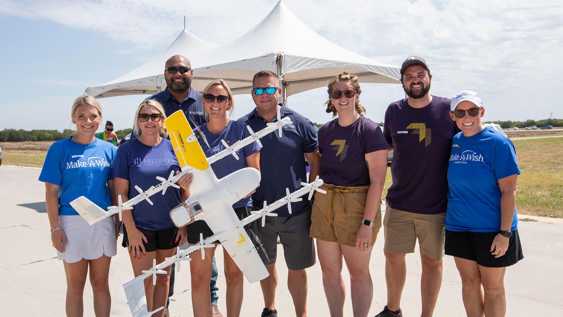 Hillwood employees are shown with a large model plane.
