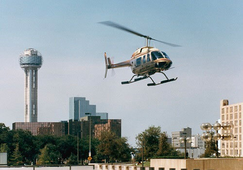 A helicopter lands in Dallas after Ross Perot Jr. and Jay Coburn complete the first round-the-world flight in 29 days, 3 hours and 8 minutes.