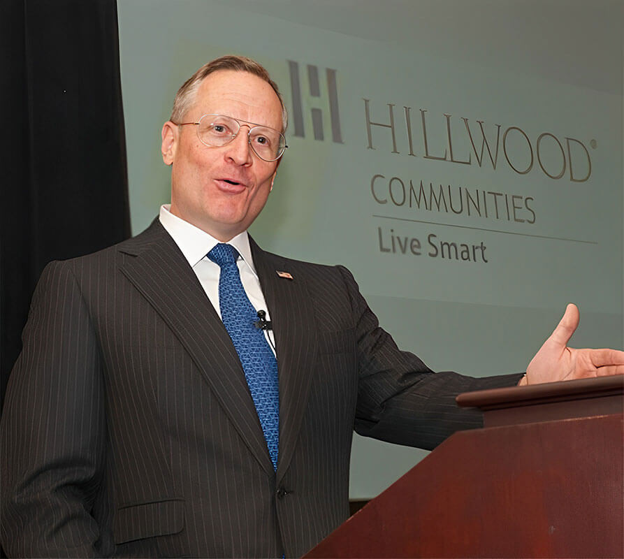 Ross Perot Jr. is shown at a lectern, announcing that Hillwood Residential will become Hillwood Communities.