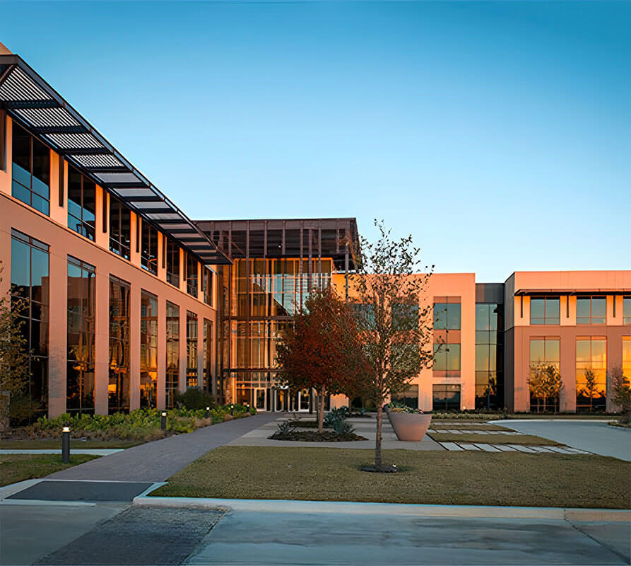 Sunset photo of a glass-fronted building that becomes Hillwood’s Fort Worth offices.