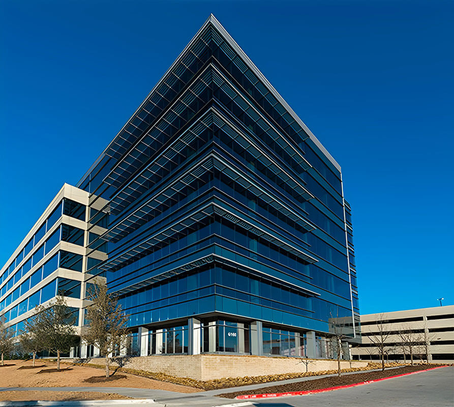 A glass, seven-story office building is part of the Frisco Station mixed-use development.