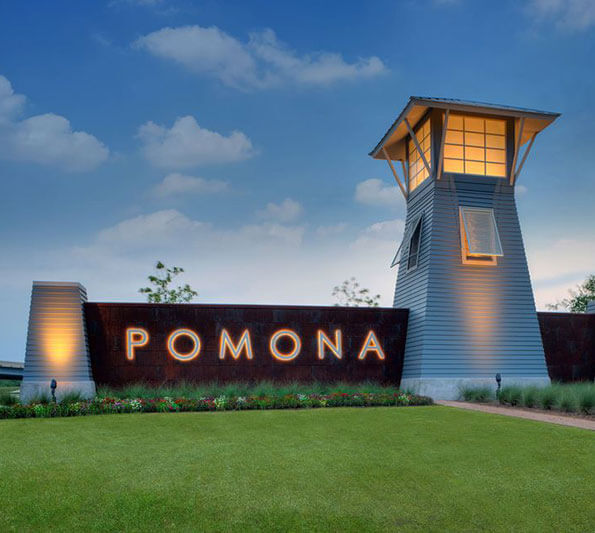 A sign reading, 'Pomona' on a lighthouse-looking structure at the entry of a Hillwood Communities project near Houston.