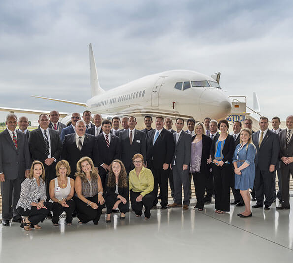 Hillwood employees gather in front of a jet as Hillwood Airways is launched.