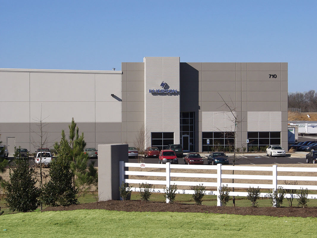 A brown-colored building, fronted by a fence, reads 'Emerson'.