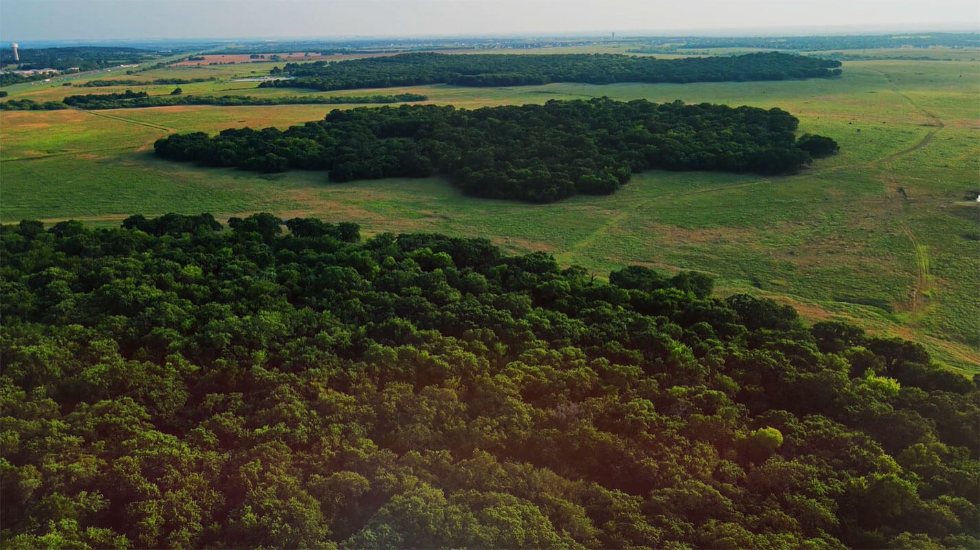 Green fields and groves of trees are seen from the air in Denton, Texas.