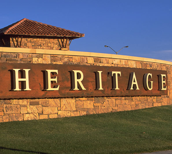 A curved brick sign reads, 'Heritage'.
