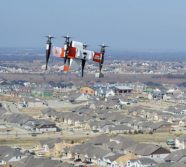 A package-carrying drone flies above Northlake, Texas.