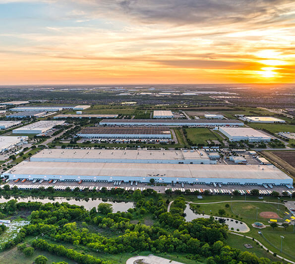 Buildings and landscaping that make up Hillwood’s AllianceTexas development are seen from the air at sunset.