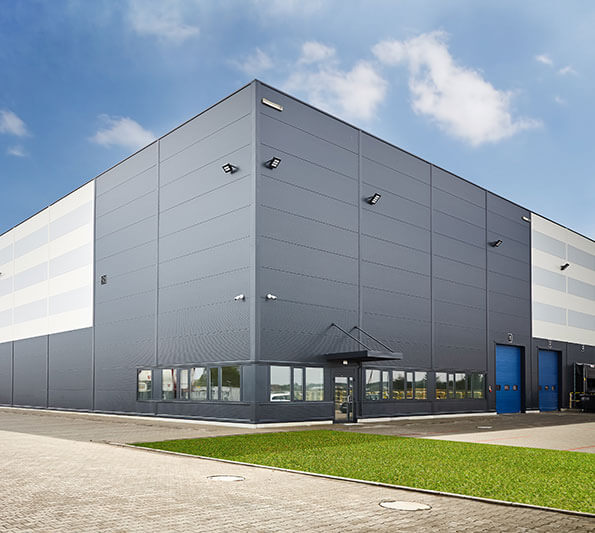 A tall, gray- and silver-colored industrial building.